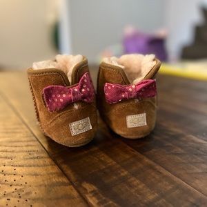 UGG boots with pink bow.
